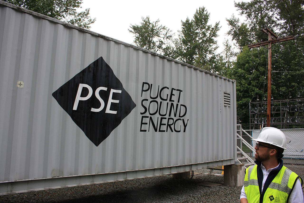 Puget Sound Energy product development manager John Dooley stands in front of one of four units at the Glacier Battery Storage Project in northwest Washington state. The project can provide power to the small town of Glacier for around two hours if needed. Aaron Kunkler/staff photo