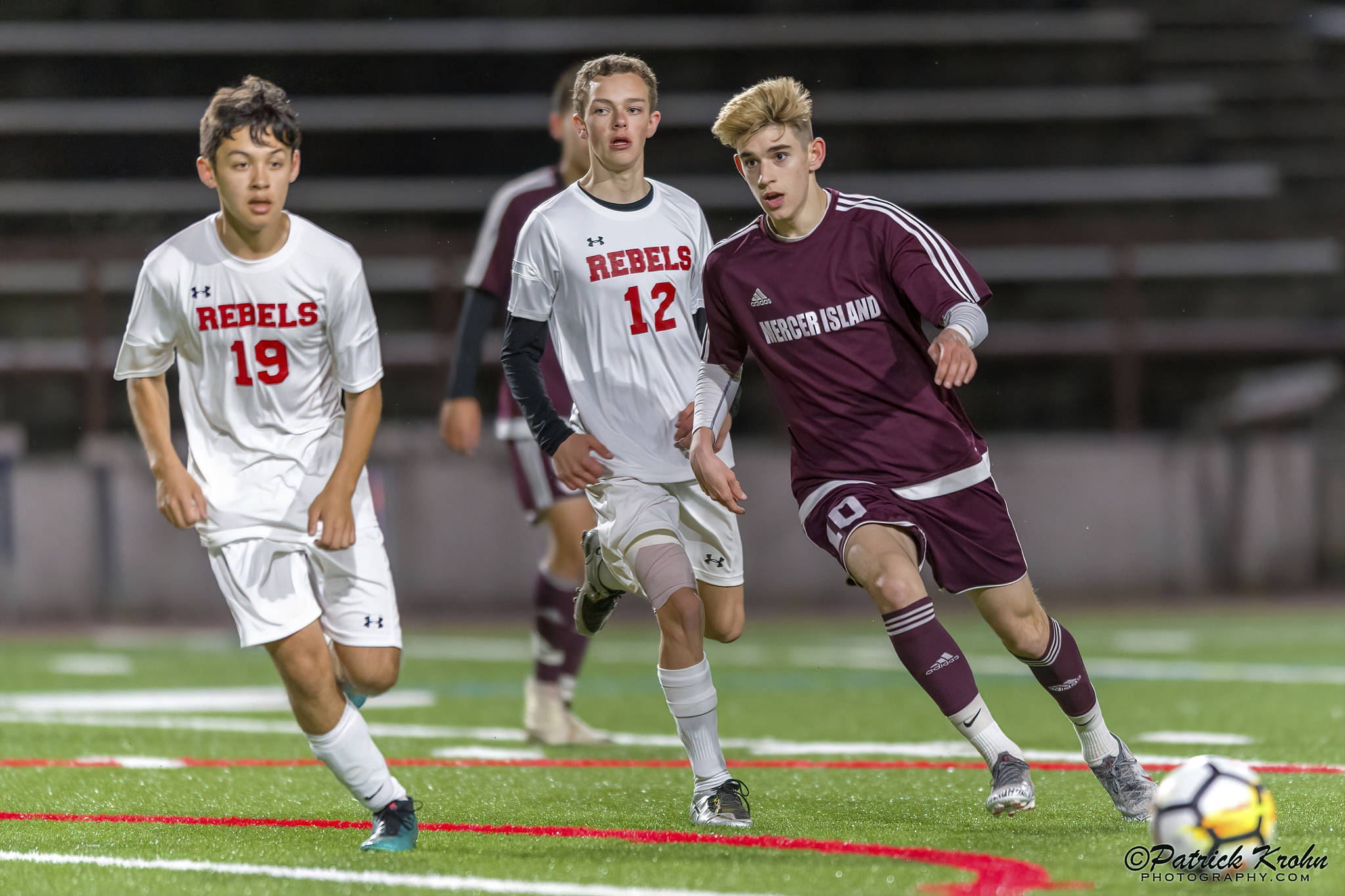 Mercer Island Islanders midfielder Matt Capone (right), passes the ball to a teammate in a contest against the Juanita Rebels during the 2019 season. Capone will play soccer at Northwest Nazarene University this fall. Photo courtesy of Patrick Krohn/Patrick Krohn Photography