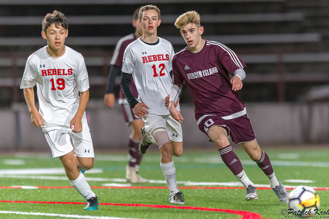Mercer Island Islanders midfielder Matt Capone (right), passes the ball to a teammate in a contest against the Juanita Rebels during the 2019 season. Capone will play soccer at Northwest Nazarene University this fall. Photo courtesy of Patrick Krohn/Patrick Krohn Photography