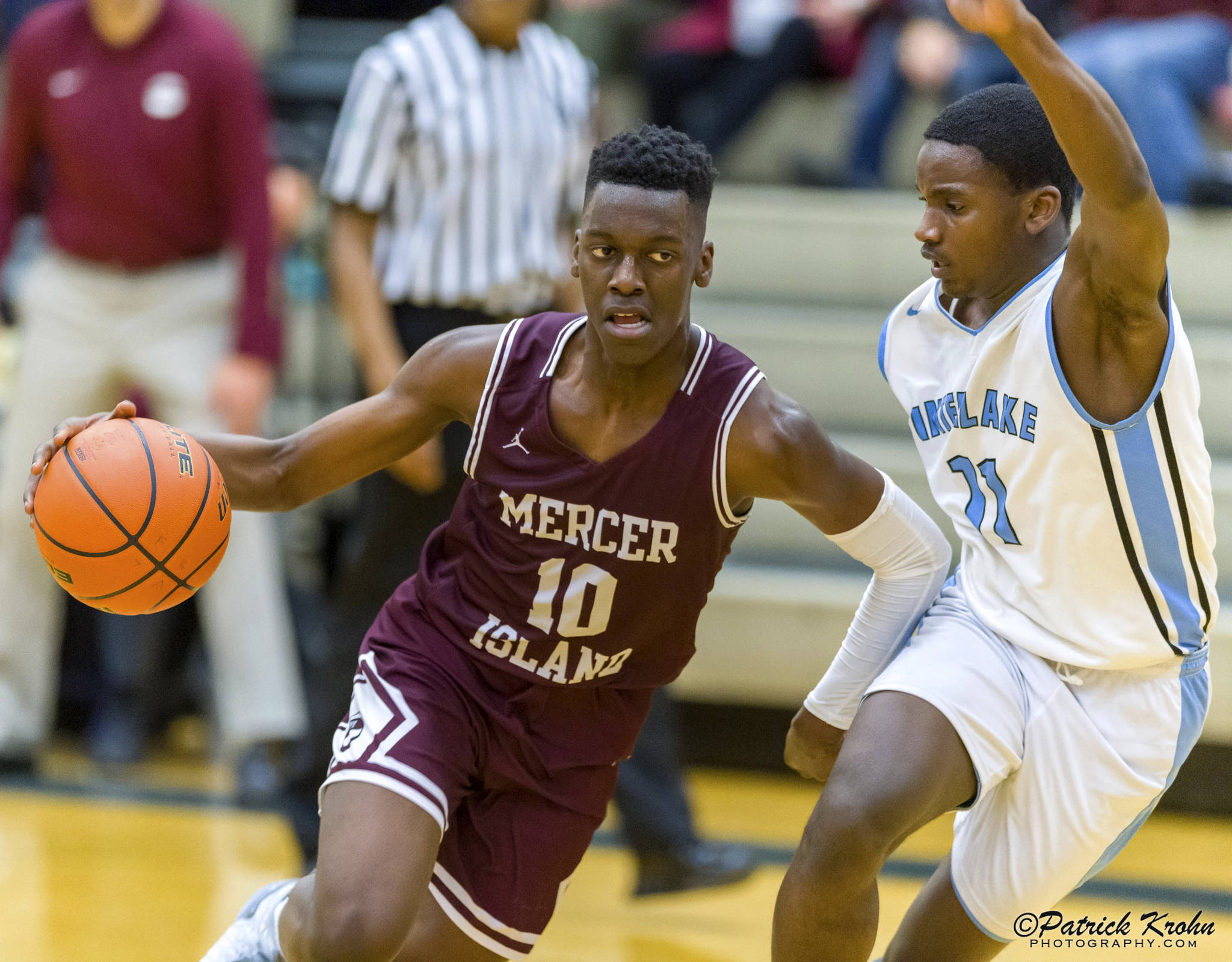 Mercer Island Islanders boys basketball player Nigel Seda, left, drives to the hoop in a game against the Interlake Saints during the 2018-19 season. Seda will be one of four returners to the starting lineup during the 2019-20 season. Photo courtesy of Patrick Krohn/Patrick Krohn Photography