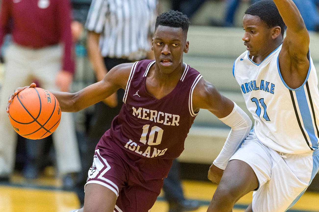 Mercer Island Islanders boys basketball player Nigel Seda, left, drives to the hoop in a game against the Interlake Saints during the 2018-19 season. Seda will be one of four returners to the starting lineup during the 2019-20 season. Photo courtesy of Patrick Krohn/Patrick Krohn Photography