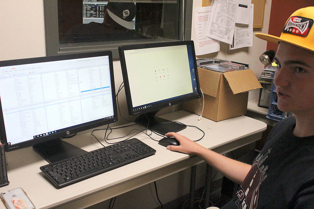 Mason Meinzinger, an incoming MIHS sophomore, works to organize the 500-plus song playlist for Log Boom Radio. Madison Miller / staff photo