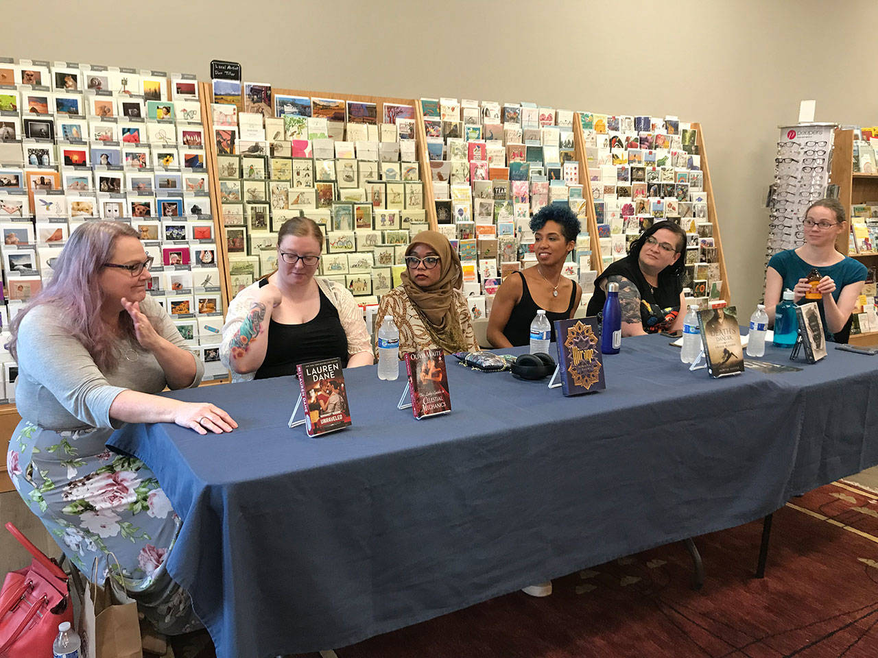 Photo by Samantha Pak/staff photo                                Authors, from left, Lauren Dane, Olivia Waite, Somaiya Daud, Jasmine Silvera and A.J. Hackwith and moderator Casey Blair discuss reclaiming history at Brick & Mortar Books in Redmond.
