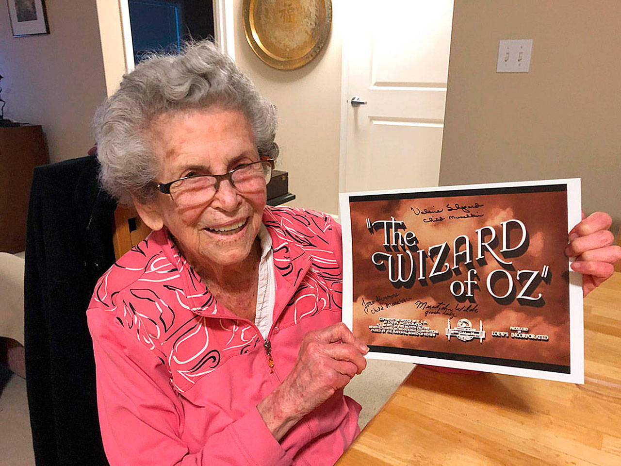 Mercer Island resident Meredythe Glass poses with memorabilia from “The Wizard of Oz.” Glass was an extra in the film, and was be the guest of honor at a party at her retirement community celebrating Hollywood on Feb. 22. Photo courtesy of Greg Asimakoupoulos