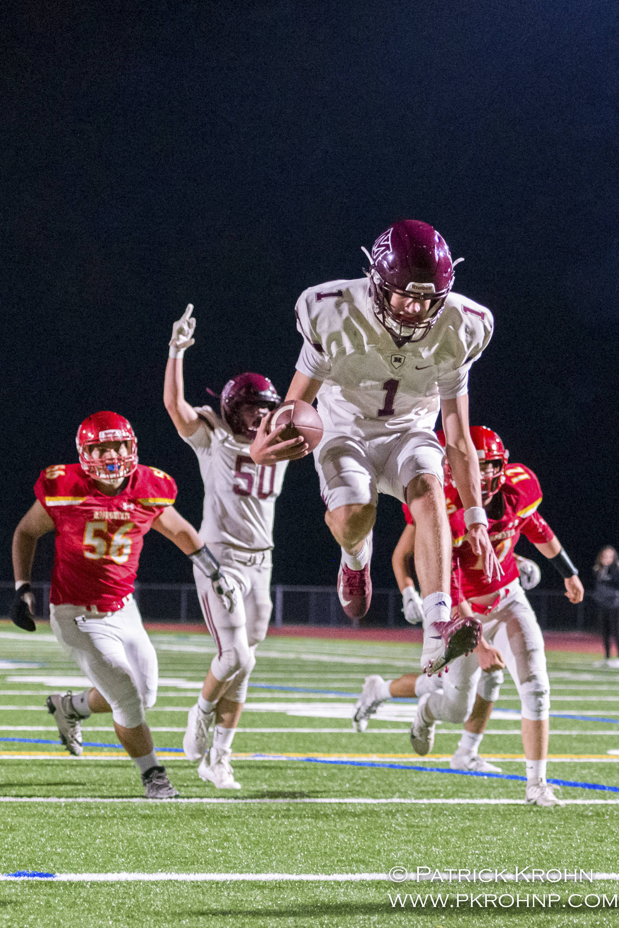 Mercer Island quarterback Liam Rogan leaps into the end zone in the second quarter of their 27-17 victory over the Newport Knights on Sept. 20. Photo courtesy of Patrick Krohn/Patrick Krohn Photography
