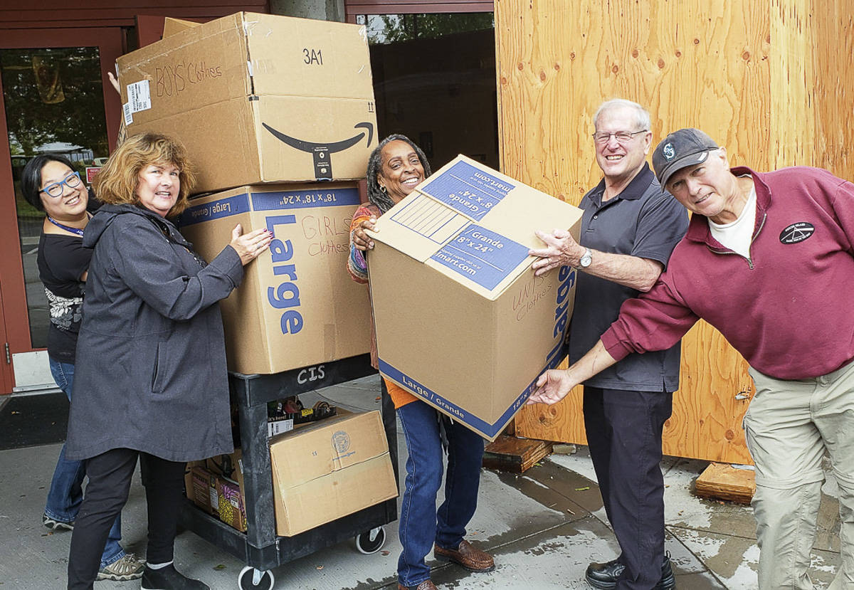 Courtesy photo                                From left, Kam Yee, Karolyn Streck, Nina Bowman, Steve Sheppard and John Faith load donated clothes boxes on a cart at Rising Star Elementary School.