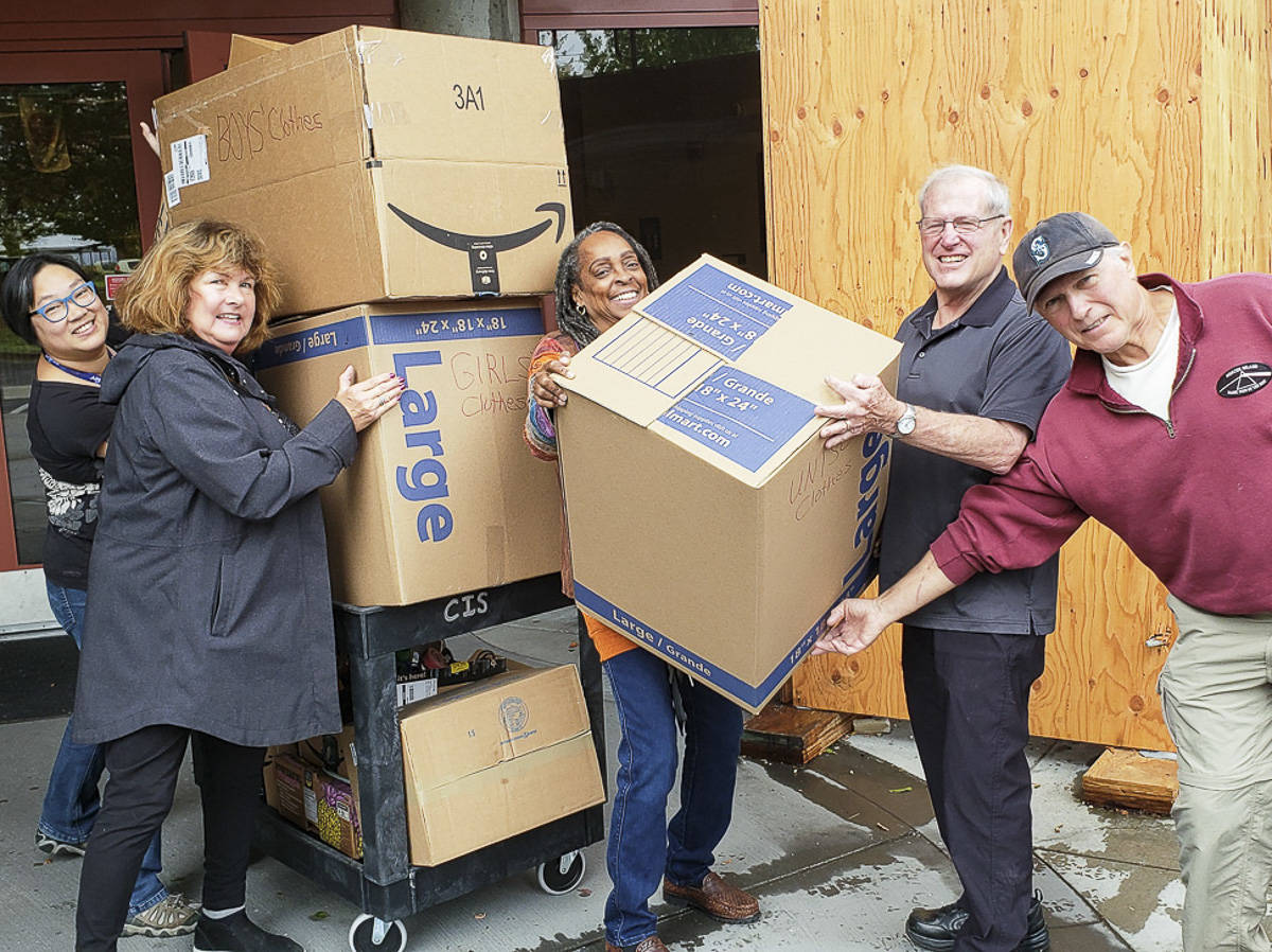 Courtesy photo                                From left, Kam Yee, Karolyn Streck, Nina Bowman, Steve Sheppard and John Faith load donated clothes boxes on a cart at Rising Star Elementary School.