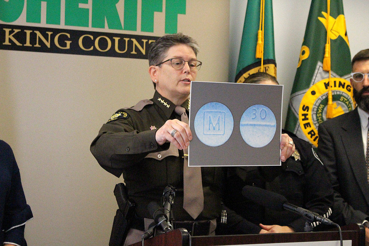 Madison Miller / staff photo                                King County Sheriff Mitzi G. Johanknecht shows what M30 pills look like at a news conference Wednesday.