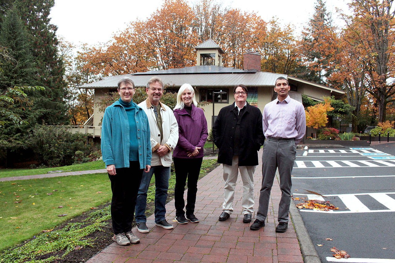 Photo by Natalie DeFord/staff photo                                From left, energy team Rev. Roberta Rominger, Hans Fredrikson, Cheryl Malcham, Jonathan Harrington and Jay Mavoori in front of Congregational Church on Mercer Island, whose new solar panels are on the roof.