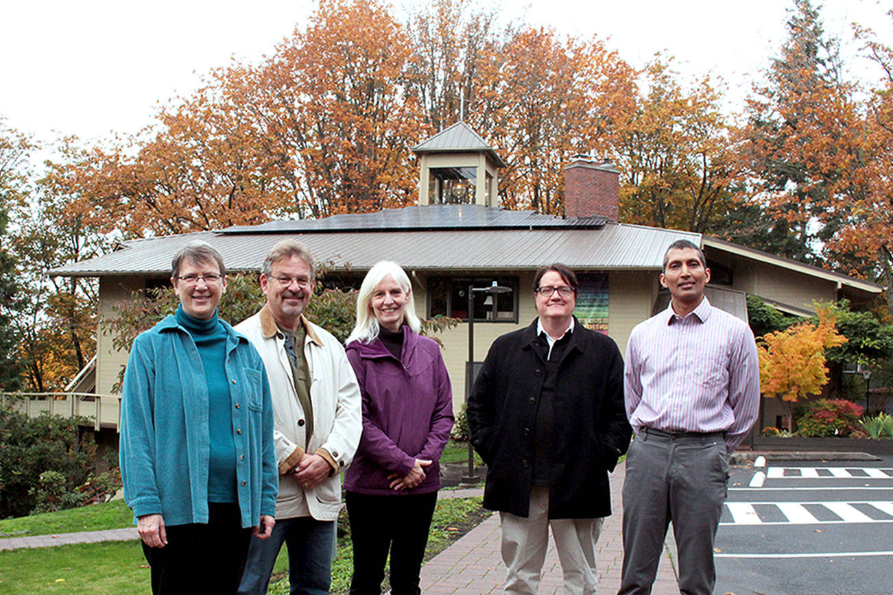 Photo by Natalie DeFord/staff photo                                From left, energy team Rev. Roberta Rominger, Hans Fredrikson, Cheryl Malcham, Jonathan Harrington and Jay Mavoori in front of Congregational Church on Mercer Island, whose new solar panels are on the roof.