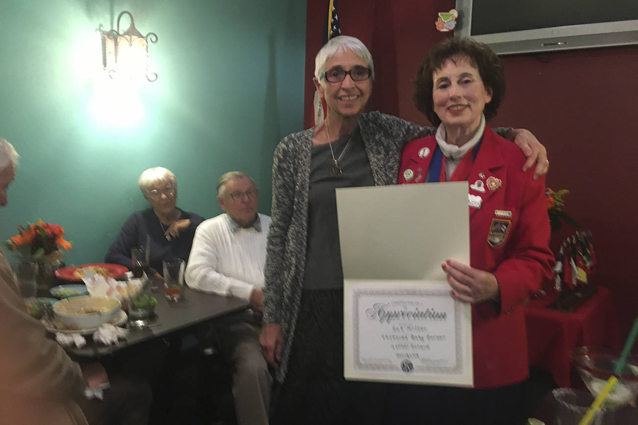 Eastside Baby Corner collection chairperson Sue Miller receiving a Kiwanis service appreciation award from club president Carol Mahoney.