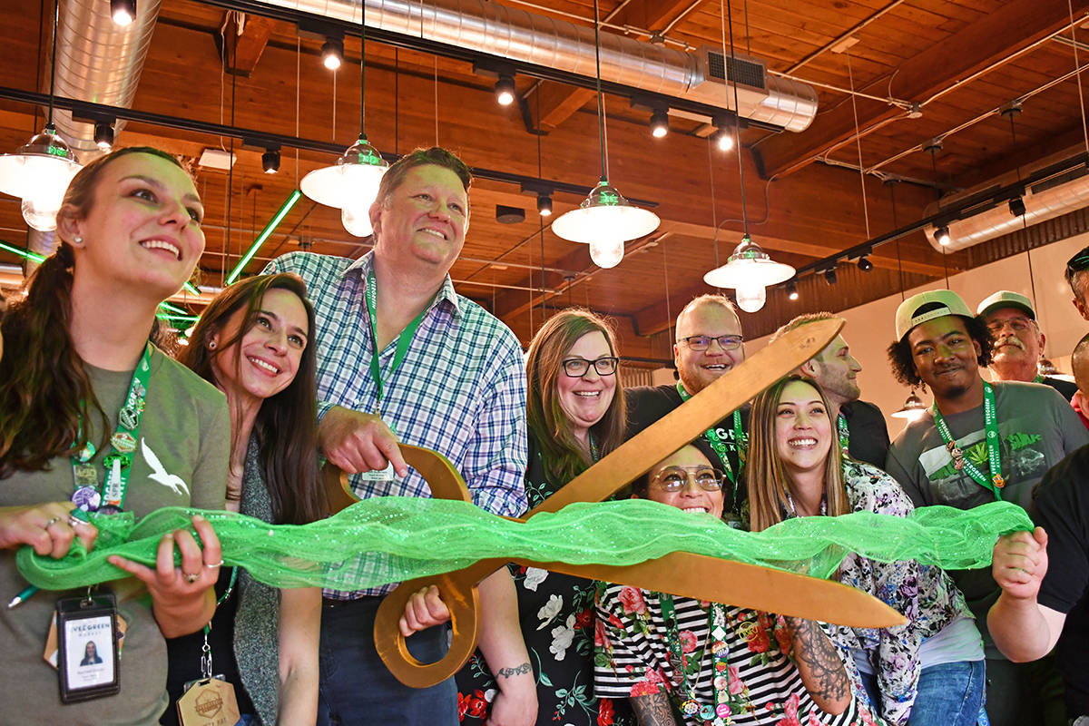 Staff and management of The Evergreen Market’s fifth and newest store, in Bellevue, celebrate the location’s grand opening in August.