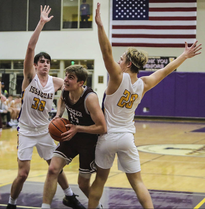 Mercer Island forward Luke Wenzel (middle) drives to the net during a 62-54 victory over Issaquah on Dec. 4. Photo courtesy of Don Borin/Stop Action Photography