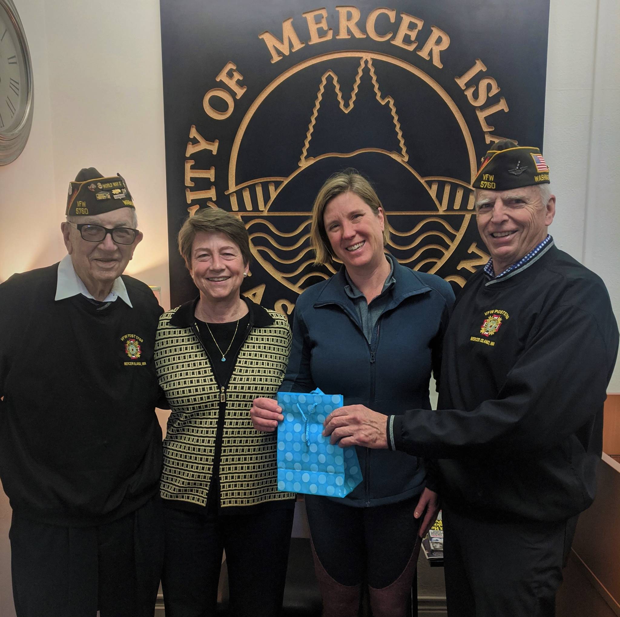 Dean Quigley and Bob Harper, on behalf of the Mercer Island VFW Post 5670, present a $1,000 donation to MIYFS director Cynthia Goodwin and foundation president Jody Kris on Nov. 14. Photo courtesy of Bob Harper