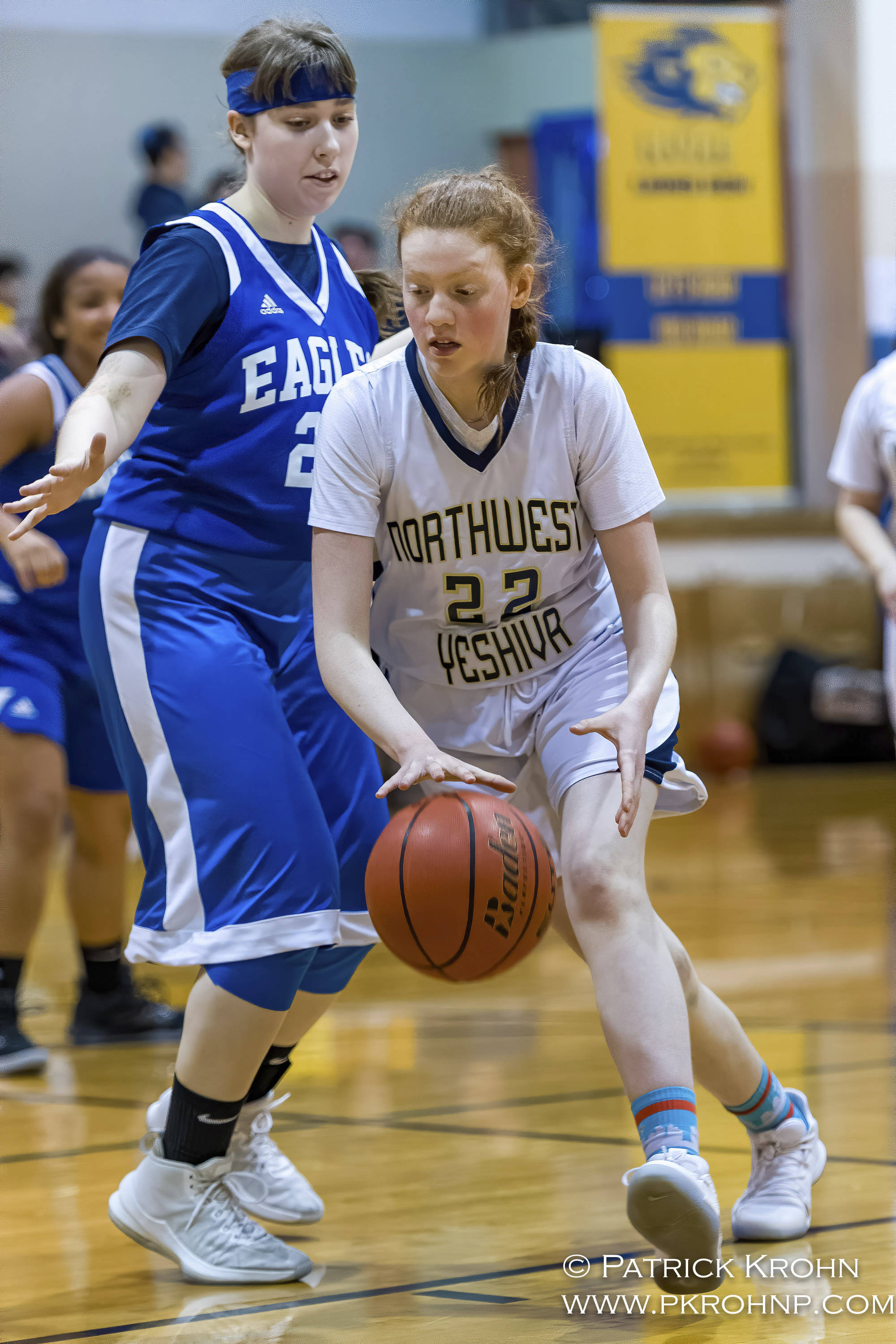 Northwest Yeshiva forward Eliana Menashe (right) dribbles the ball during the Lions basketball game against the Grace Academy Eagles on Dec. 14. Photo courtesy of Patrick Krohn/Patrick Krohn Photography