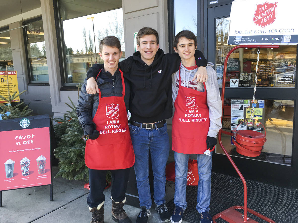 Mercer Island High School Interact Club members participated in bell ringing for Salvation Army with the Rotary Club of Mercer Island in late November and December 2019. From left: Charles Wischman, Peyton Rapo and Mathis Destouches. Courtesy photo.