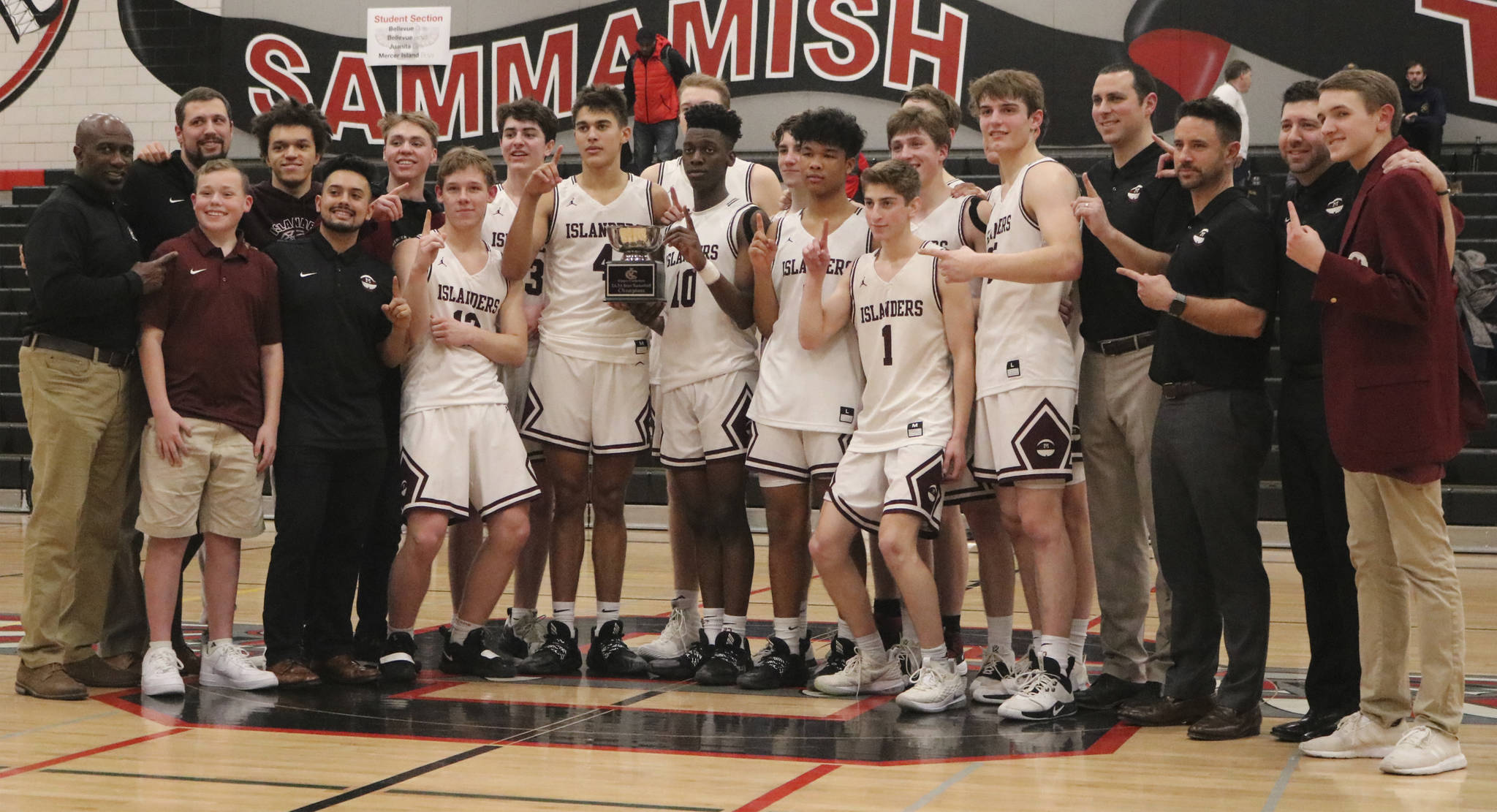 The Mercer Island boys basketball team celebrates its 61-36 victory over Interlake in the 3A KingCo championship game on Feb. 11 at Sammamish High School. Benjamin Olson/staff photo