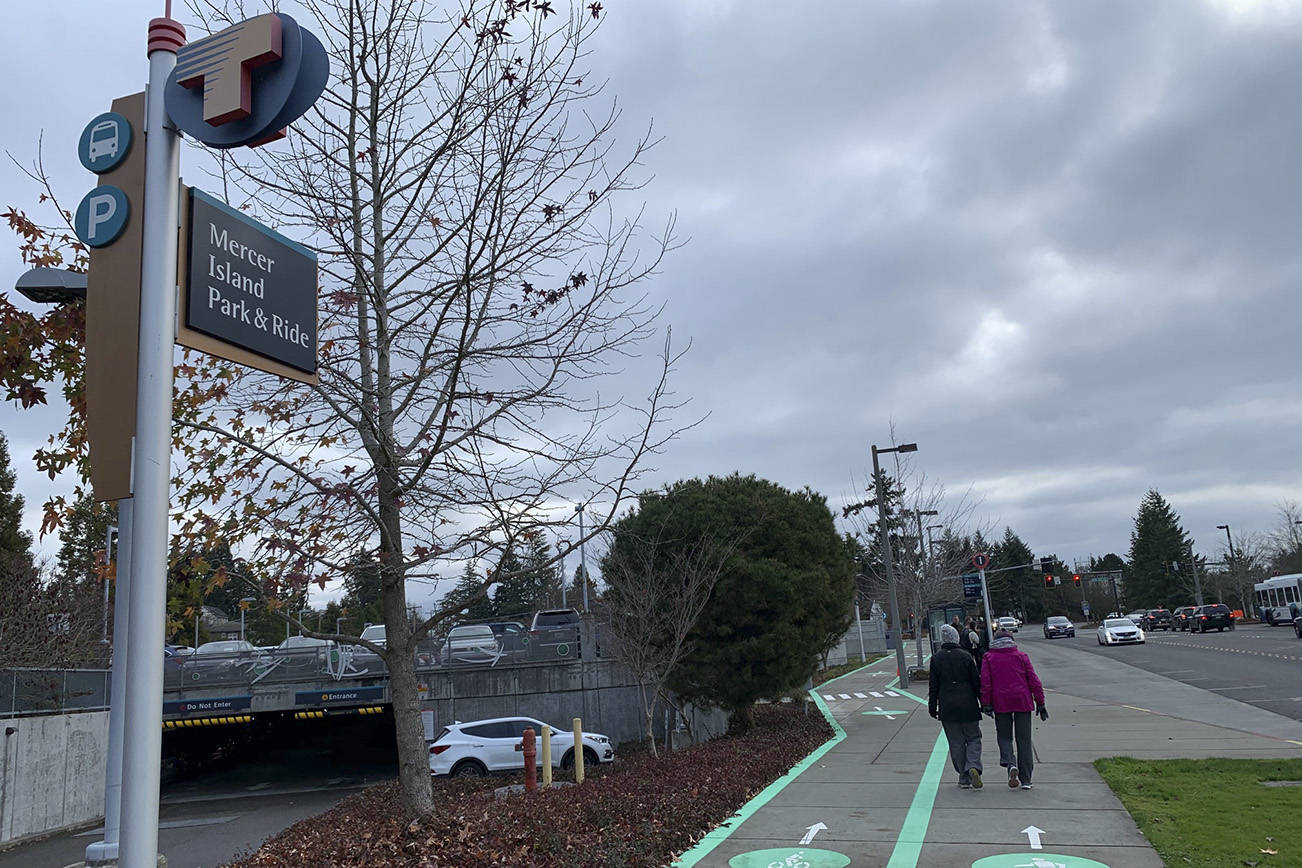 Natalie DeFord / staff photo                                People walk past the Mercer Island Park and Ride on a cloudy morning.