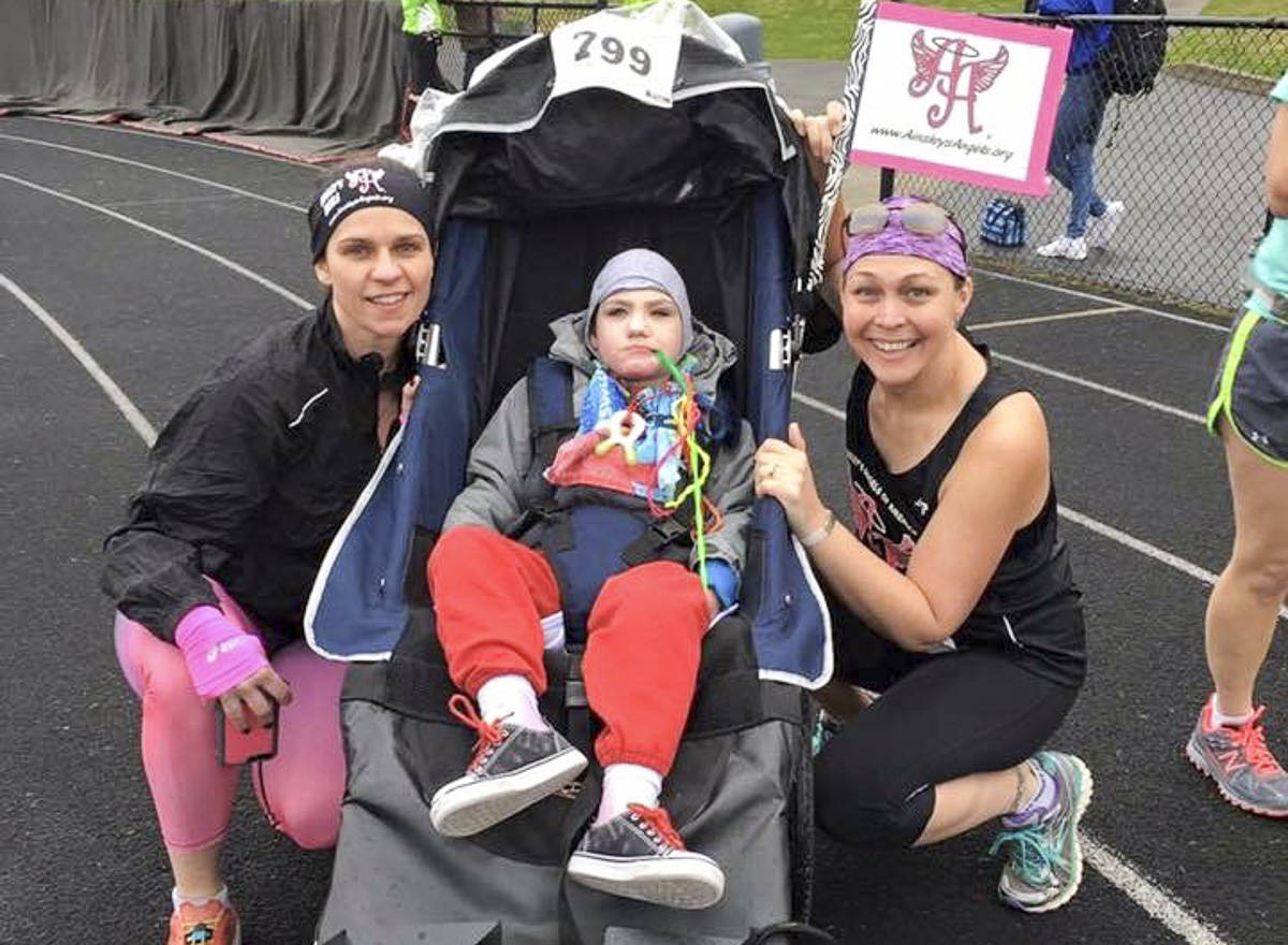 Courtesy photo                                From left, Sarah Poppe, James Mattson and April Shrum participating at a previous race event as part of nonprofit Ainsley’s Angels.