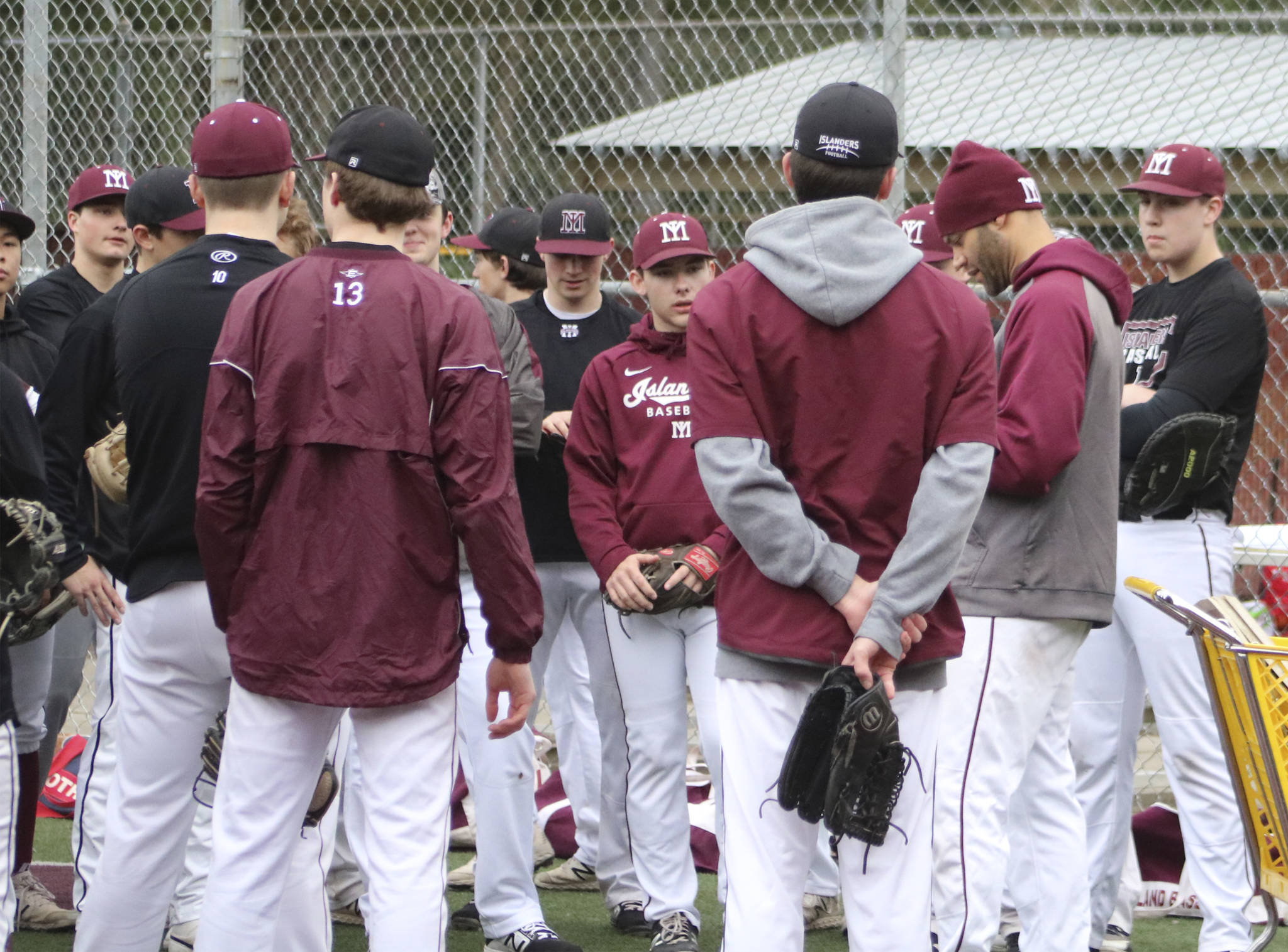 The Mercer Island baseball team gathers before a practice on March 5 at Island Crest Park. Benjamin Olson/staff photo