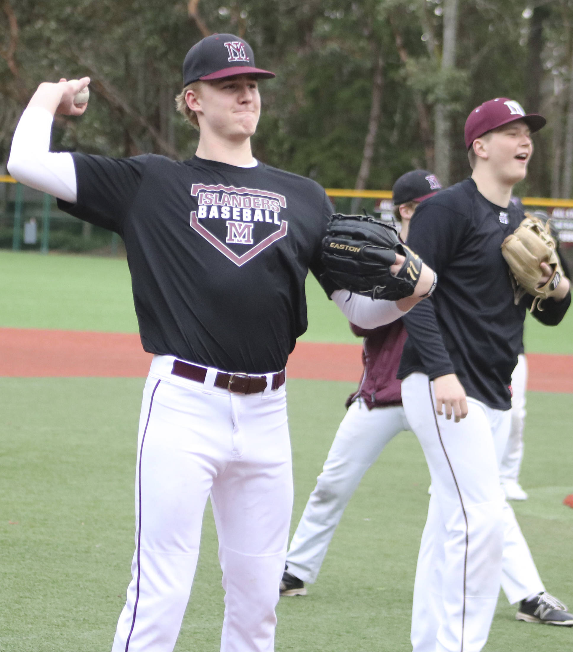 Mercer Island pitcher Duke Brotherton warms up his arm during a practice on March 5 at Island Crest Park. Benjamin Olson/staff photo