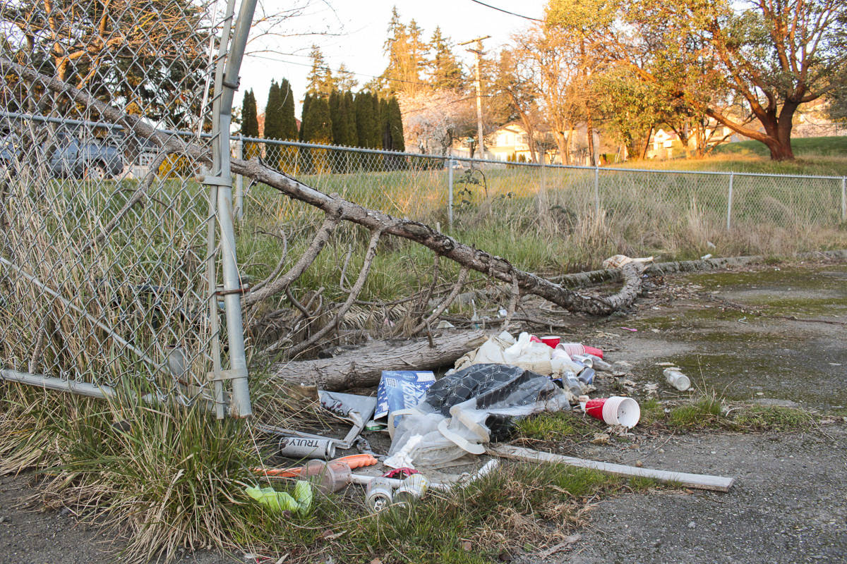 Natalie DeFord/staff photo                                Garbage and large branches at the former East Seattle Elementary School property parking lot entrance.