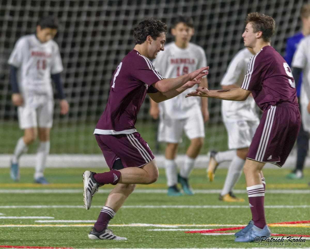 Mercer Island midfielder Luca Mtskhetadze (left) celebrates with teammate Jonah Hyman, right, after scoring on a header against Juanita last season. Photo courtesy of Patrick Krohn/Patrick Krohn Photography