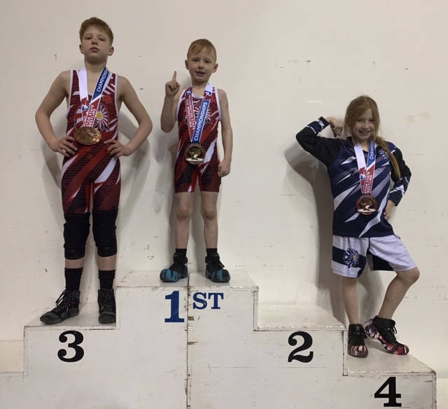 Mercer Island residents (from left) Briak Chapman, Alex Chapman and Arabella Chapman all placed at the state folkstyle wrestling championships on Feb. 23 at the Tacoma Dome. Courtesy photo