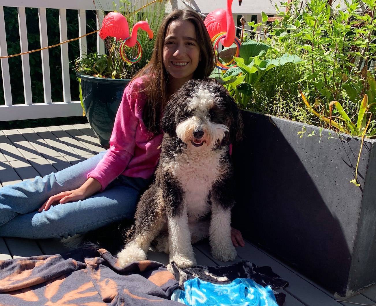 Photo courtesy Olivia Tomaselli                                Mercer Island High School sophomore Olivia Tomaselli with her dog, Cookie, and available merchandise. Fifty percent of profits accrued from Tie Dye for Black Lives Matter are directly donated to the BLM Global Network, with the rest going toward supplies.