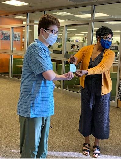 Mercer Island’s Jack Dalton delivers a $5,300 check to Federal Way School District Superintendent Dr. Tammy Campbell on Sept. 9. The money — raised during Dalton’s Holy Trinity Lutheran Church confirmation project — will be used to buy laptops for the district’s students. Courtesy photo