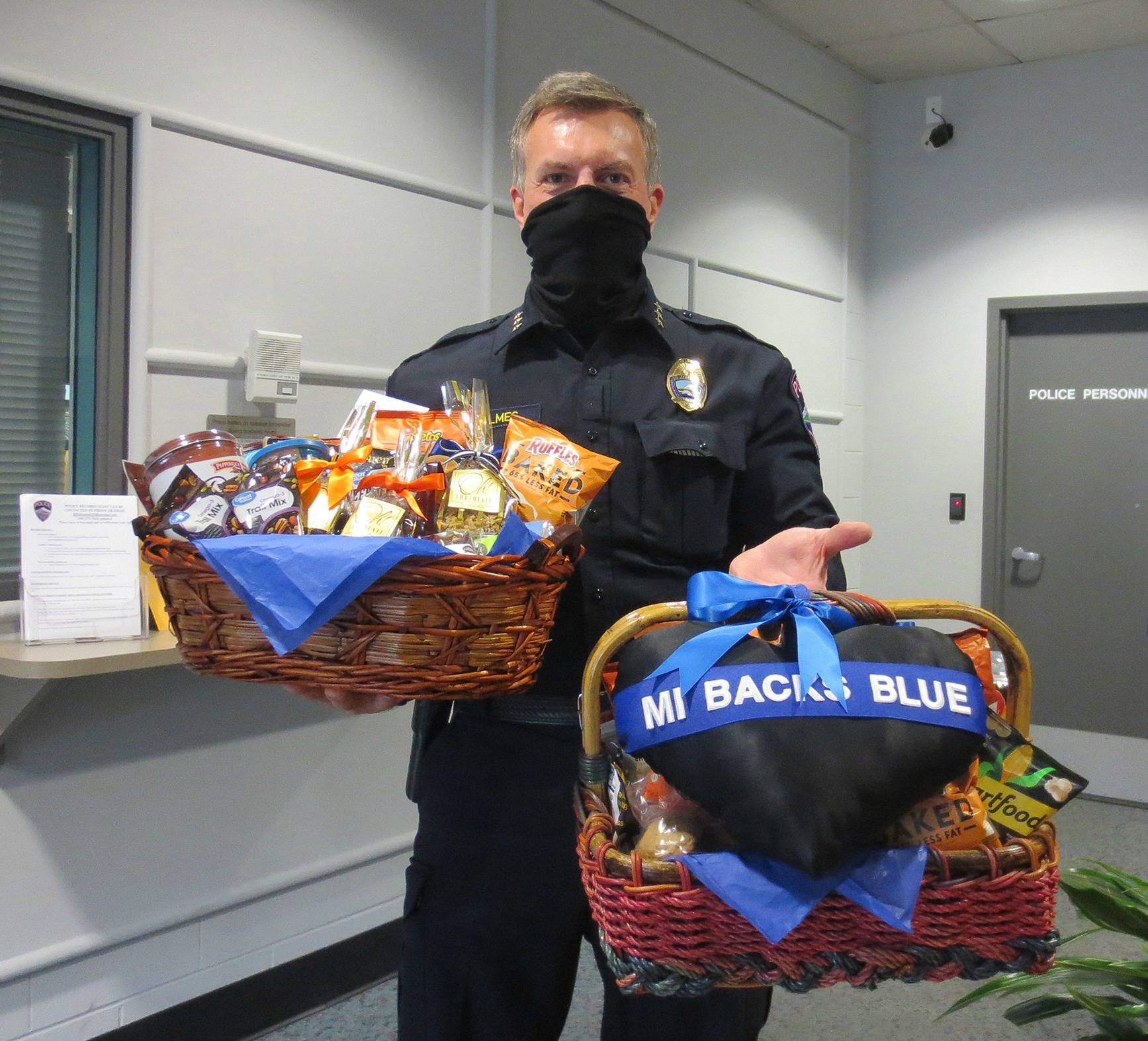 Mercer Island Police Department Chief Ed Holmes displays baskets of treats that were assembled by a group of residents to express their gratitude for the department. The baskets, which were dropped off the morning of Oct. 27, included dozens of homemade cookies, brownies and banana bread as well as popular off-the-shelf items. Courtesy photo