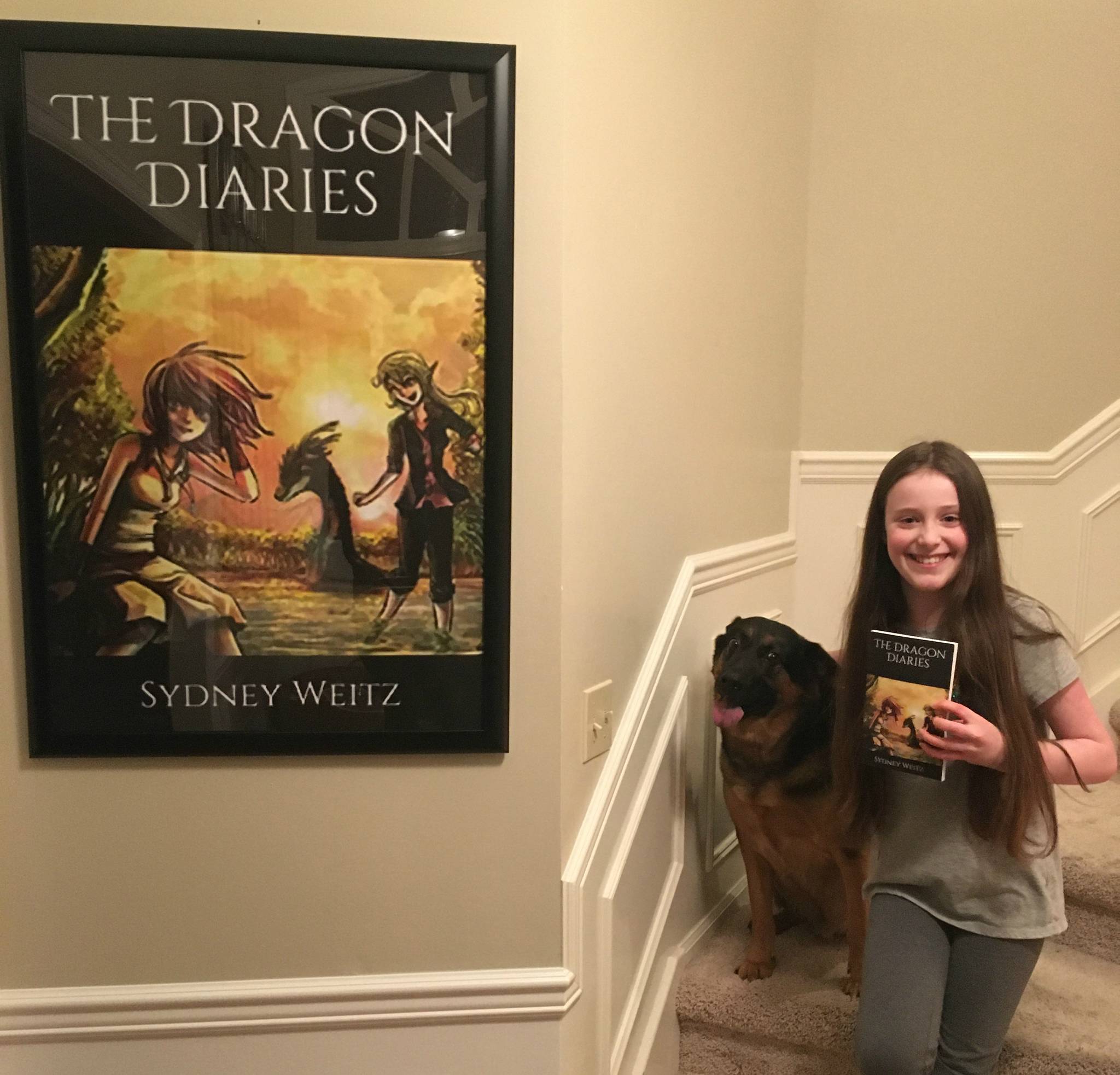 Sydney Weitz displays her book, “The Dragon Diaries,” alongside her dog, Jäger. Courtesy photo