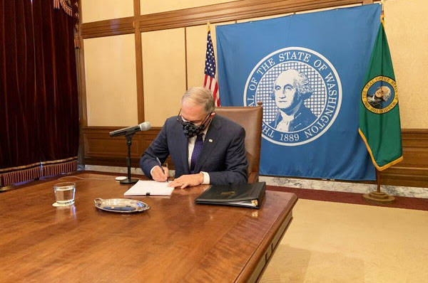 Gov. Jay Inslee signs into law Feb. 8 a bill that reduces unemployment taxes for small businesses. COURTESY PHOTO, The Office of the Governor