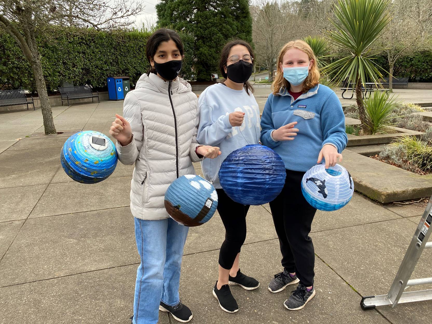 From left to right: Girl Scouts Simone Shenoi, Anahita Najafian and Molly Dudley display the lanterns they designed for the Island Lanterns community art project. Courtesy photo