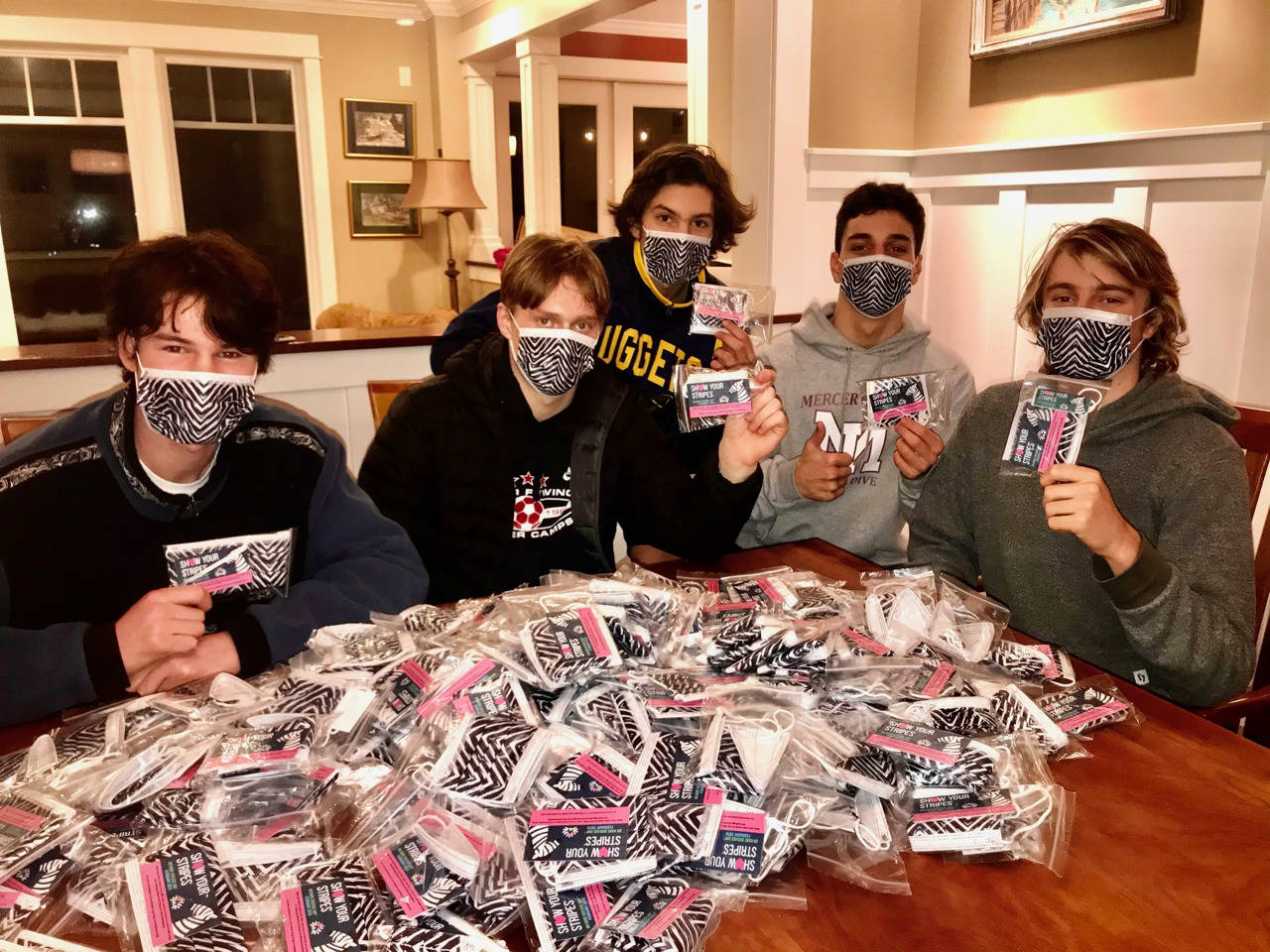 Nash Hawkins (far right) and some of his friends (from left to right, Kenny Marks, Hawkins Sanborn, James Pearce and Jacob Tomaselli) stuffed 500 zebra masks and information cards into bags for Rare Disease Day. Courtesy photo