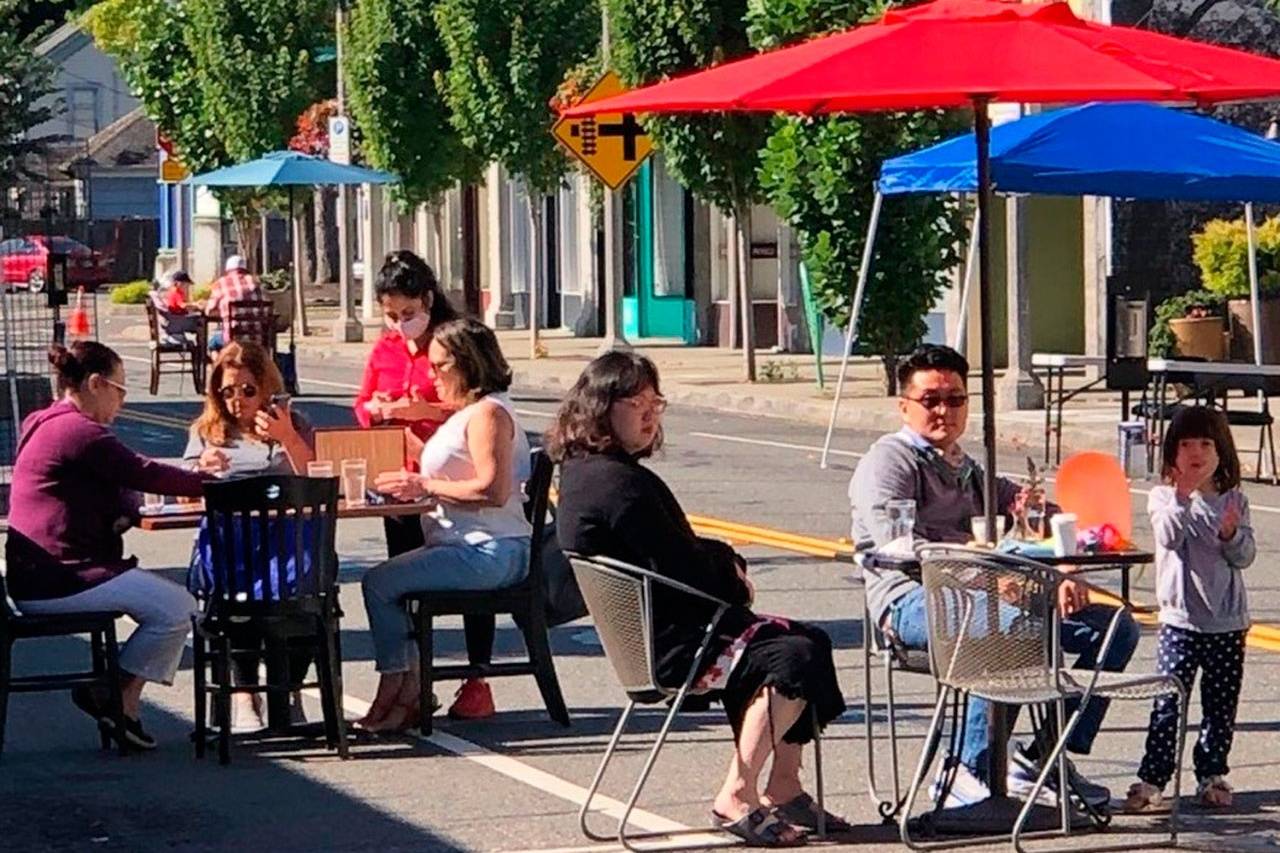 In Phase 2 of Gov. Jay Inslee’s reopening plan, which was announced Jan. 28, restaurants can reopen at a maximum 25% capacity and a limit of six people per table. Inslee recently announced all counties will be staying in Phase 2 of the state’s reopening plan for the next several weeks. Pictured: People enjoy outdoor dining last summer in downtown Kent. Courtesy photo