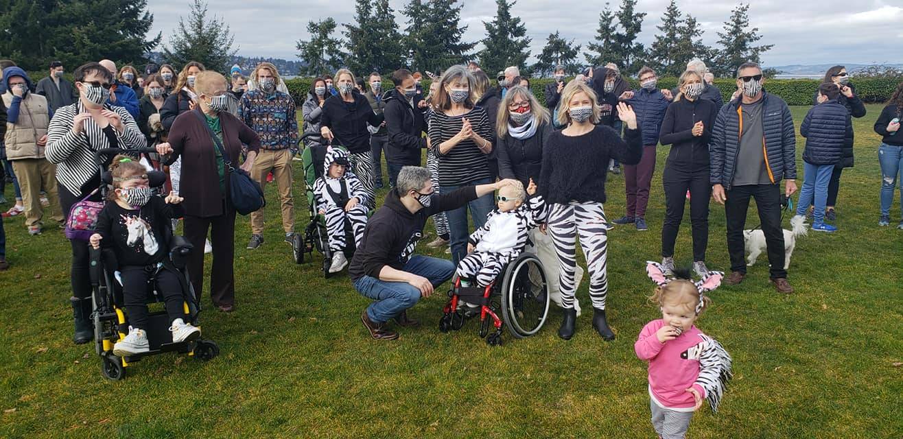 Nearly 100 people donned zebra masks and attire during a Rare Disease Day “Show Our Stripes” gathering on Feb. 28 on Mercer Island’s Lid Park. Jill Hawkins welcomed the crowd along with Effie Parks, both moms of children with rare diseases. The city embraced the families and issued a proclamation for Rare Disease Day at the Feb. 16 city council meeting. On the business front, a host of local spots offered free zebra-striped masks. The zebra is the symbol for rare disease awareness. Photo courtesy of John Hamer