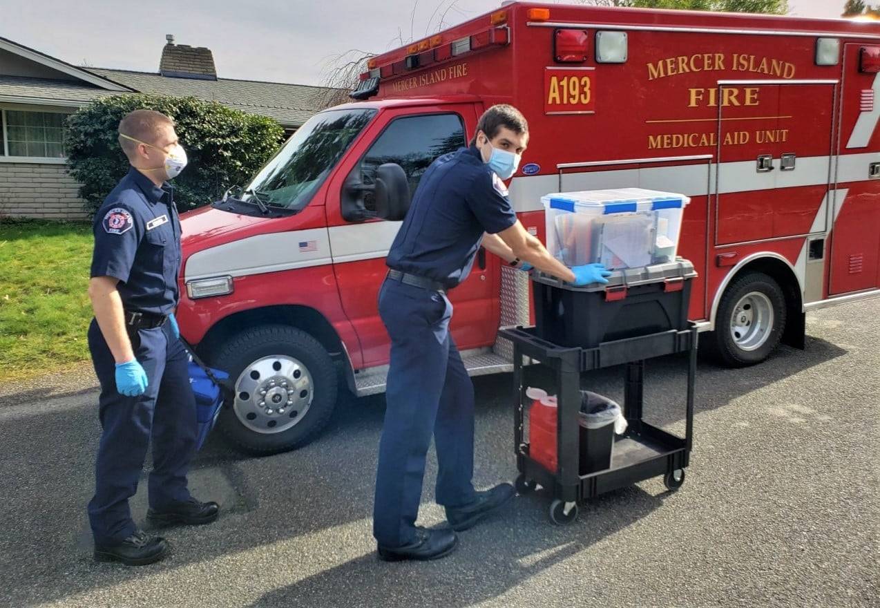 Mercer Island Fire Department emergency medical technicians Tommy Edwards (left) and Eric Gaines arrive with COVID-19 vaccine for residents at Twilight Adult Family Homes on March 8. Photo courtesy of the Mercer Island Fire Department
