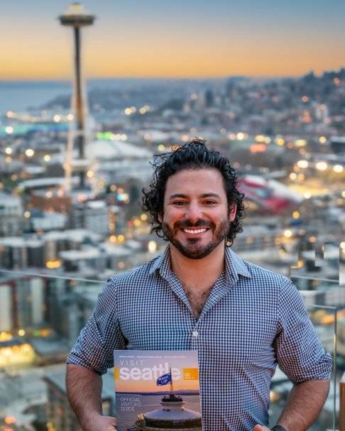 Andrew Meade holds a copy of the Visit Seattle magazine with his photo of the Space Needle on the cover. Photo courtesy of Sophia Ciserella