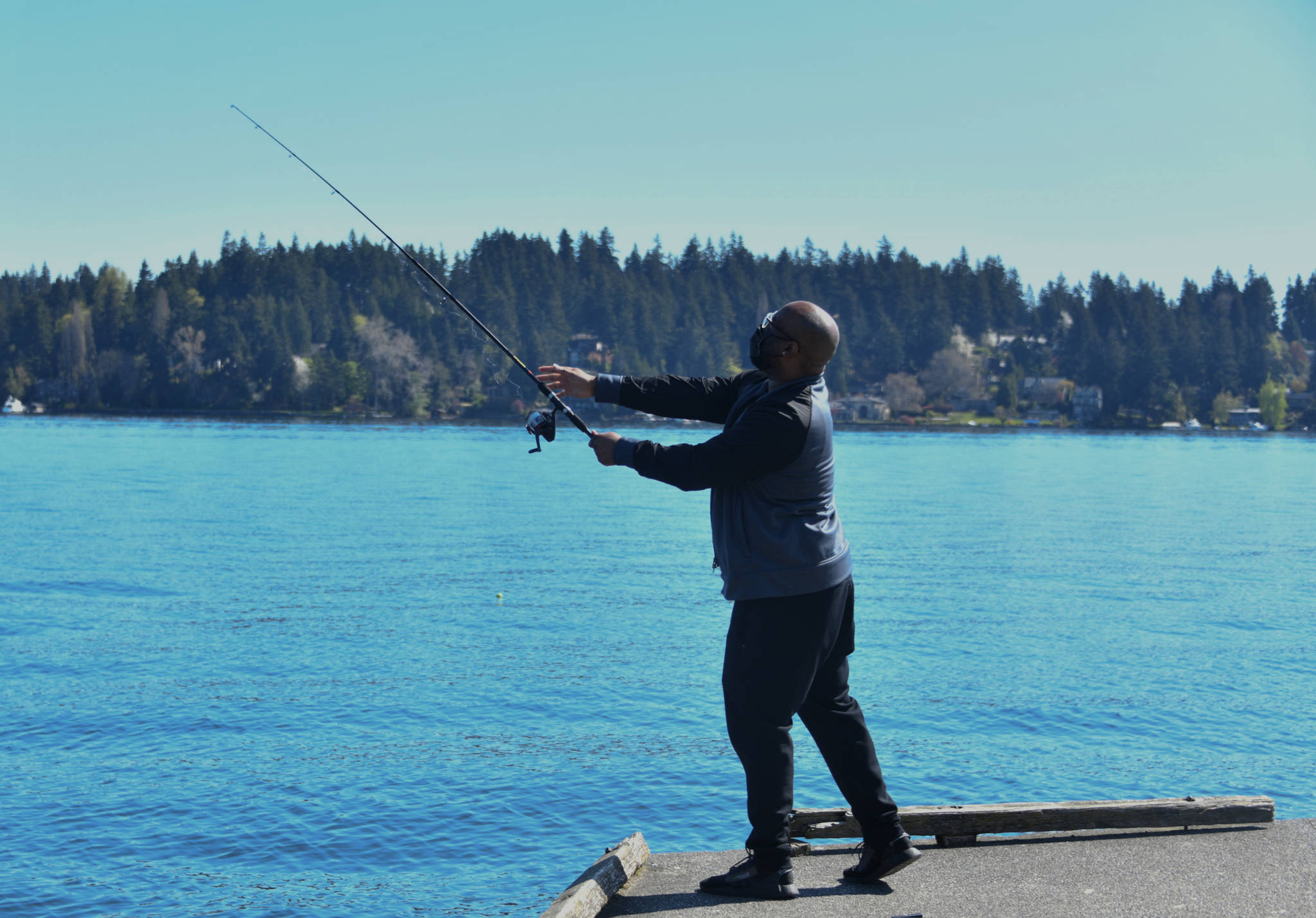 Anthony Berry gets in some fishing off a dock at Luther Burbank Park on a sunny Saturday. Temperatures reached 80 degrees in the region. Andy Nystrom/ staff photo