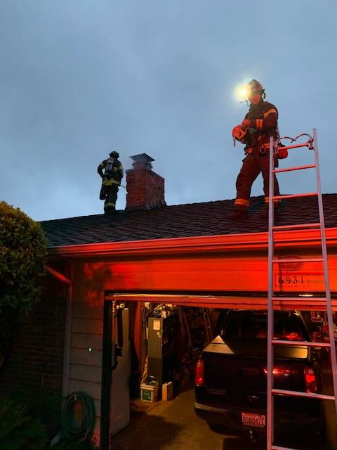 Mercer Island firefighters extinguish a chimney fire on May 3. Photo courtesy of the Mercer Island Fire Department