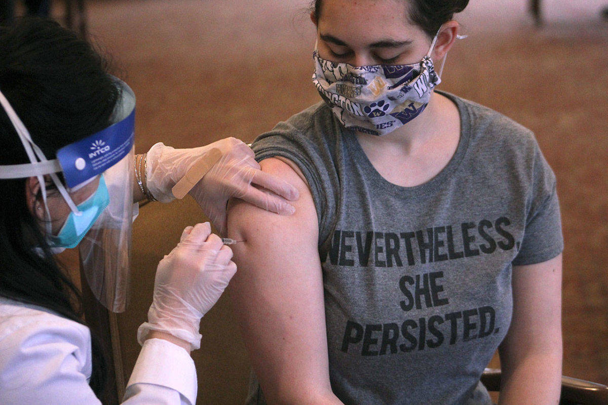 Sound Publishing file photo
Remi Frederick, a Village Green employee, receives her first dose of the Pfizer-BioNTech vaccine on Jan. 26 in Federal Way.