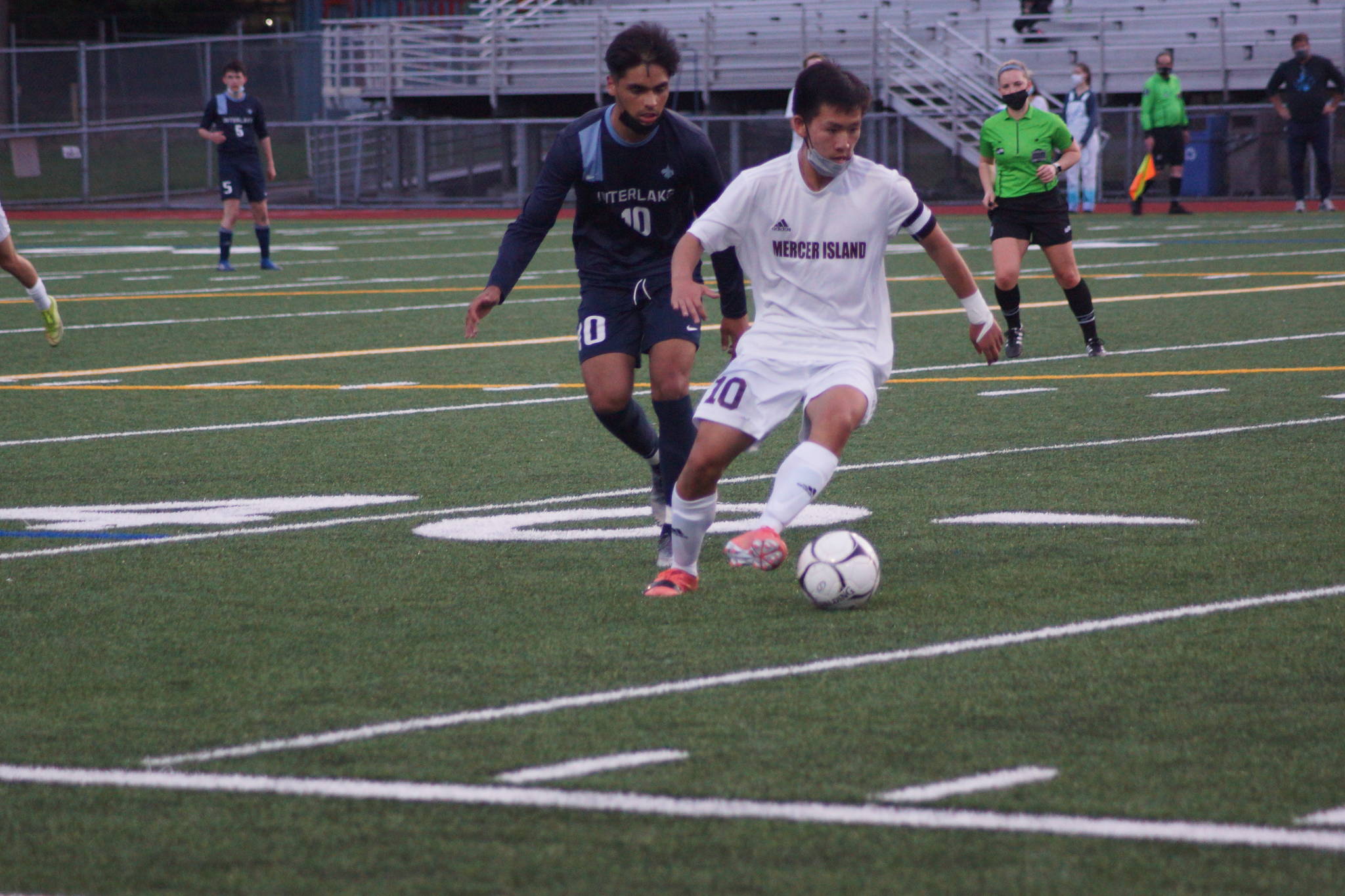 Mercer Island senior captain Josh Chang, front, controls the ball against Interlake. Photo courtesy of Lis Larkin