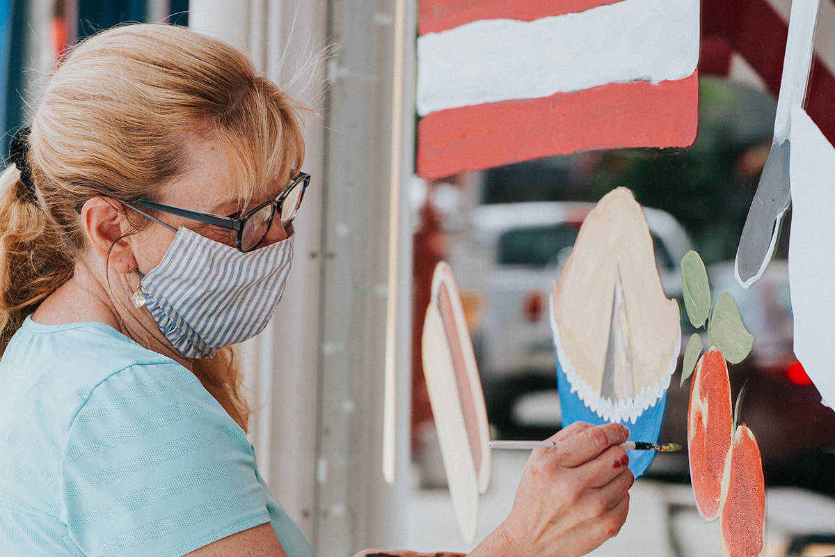 Local artist, <a href="https://www.designsbylisa.com/" target="_blank">Lisa Rasmussen</a> creating window art at Fischer Meats photo credit: <a href="https://www.jennalynnphotog.com/" target="_blank">Jenna Lynn Photography</a>