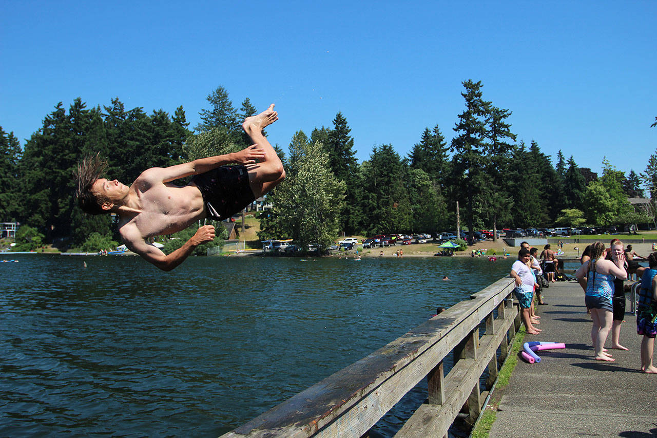 Fedor Osipov, 15, flips into Steel Lake in Federal Way on June 28. Olivia Sullivan/Sound Publishing
