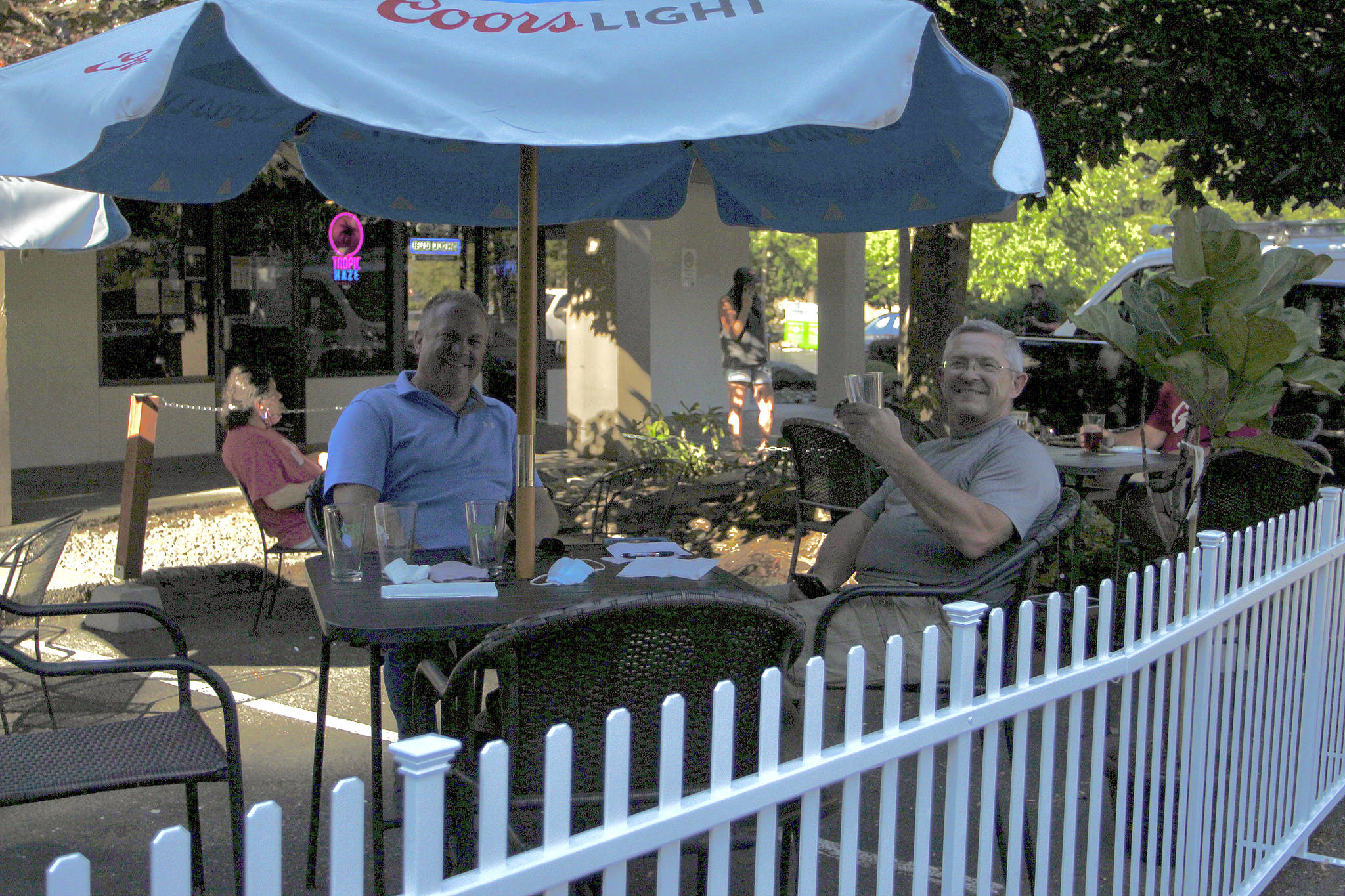 Federal Way residents Kevin Jochim, left, and Steve Reichel enjoy drinks on the new patio area at JP’s Tavern on Aug. 5, 2020. Restaurants and bars embraced outdoor seating during the pandemic. File photo