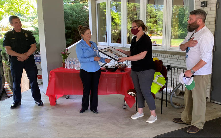 From left, Mercer Island Police Department Chief Ed Holmes, the departments emergency preparedness officer Jennifer Franklin and Kendra and Dave Uhler near the City Hall Emergency Operations Center. The Uhlers were honored for their extensive community service. Photo courtesy of the city of Mercer Island