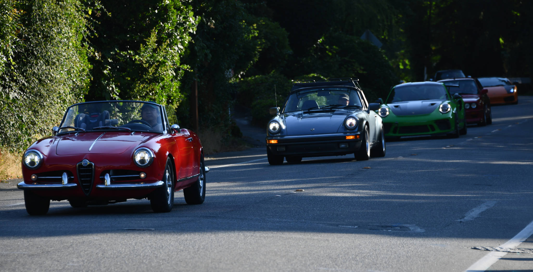 A group of cars begin cruising the Mercer Island Loop on East Mercer Way on the morning of July 24 at the Classic Car Show. Andy Nystrom/ staff photo