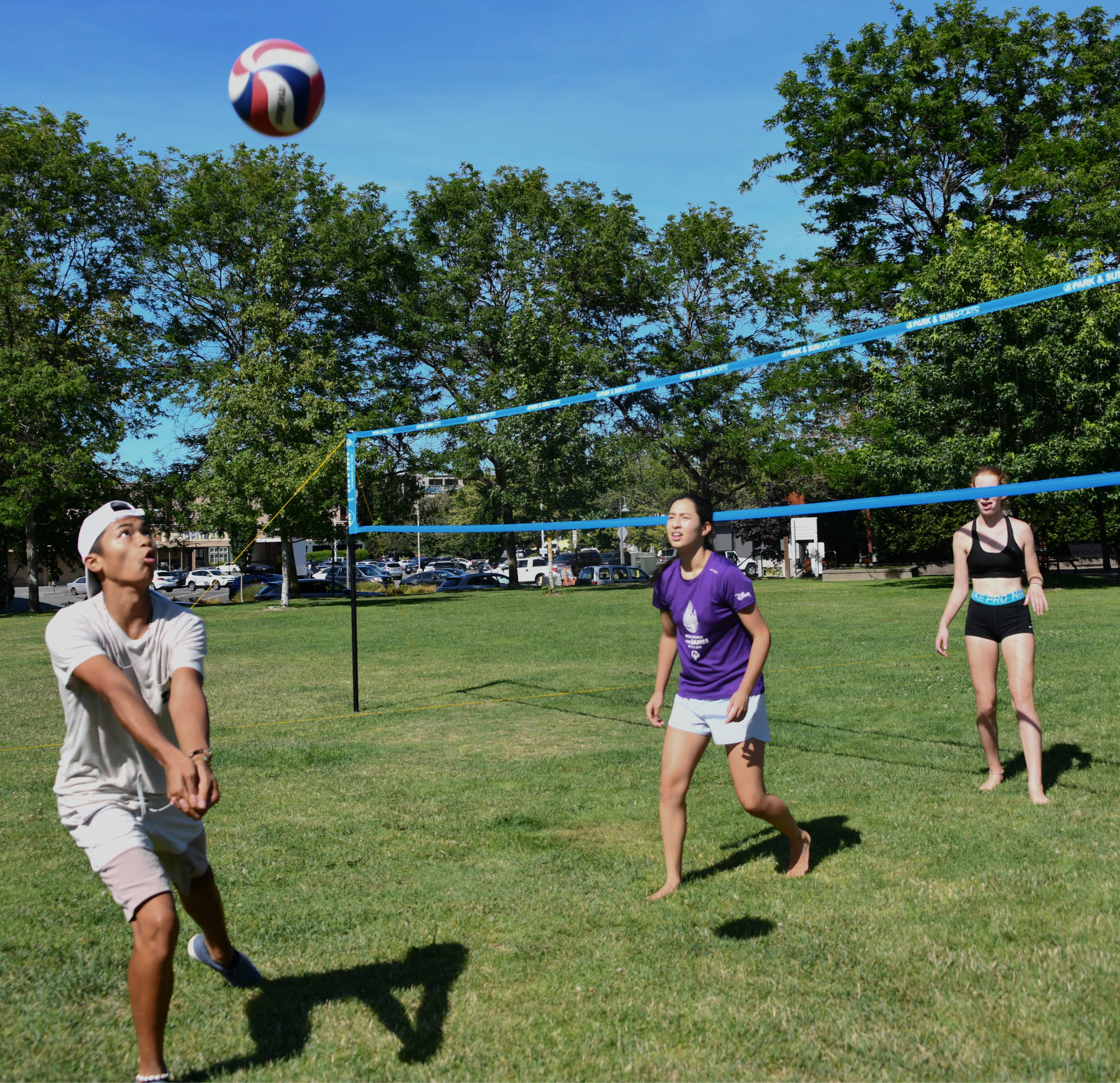 Giovee Roque, left, eyes the volleyball during an afternoon match with friends Megan Sandoval, center, and Mia Vorkoper on Aug. 10 at Mercerdale Park. Annabelle Hopkins, not pictured, was also part of the group. Andy Nystrom/ staff photo