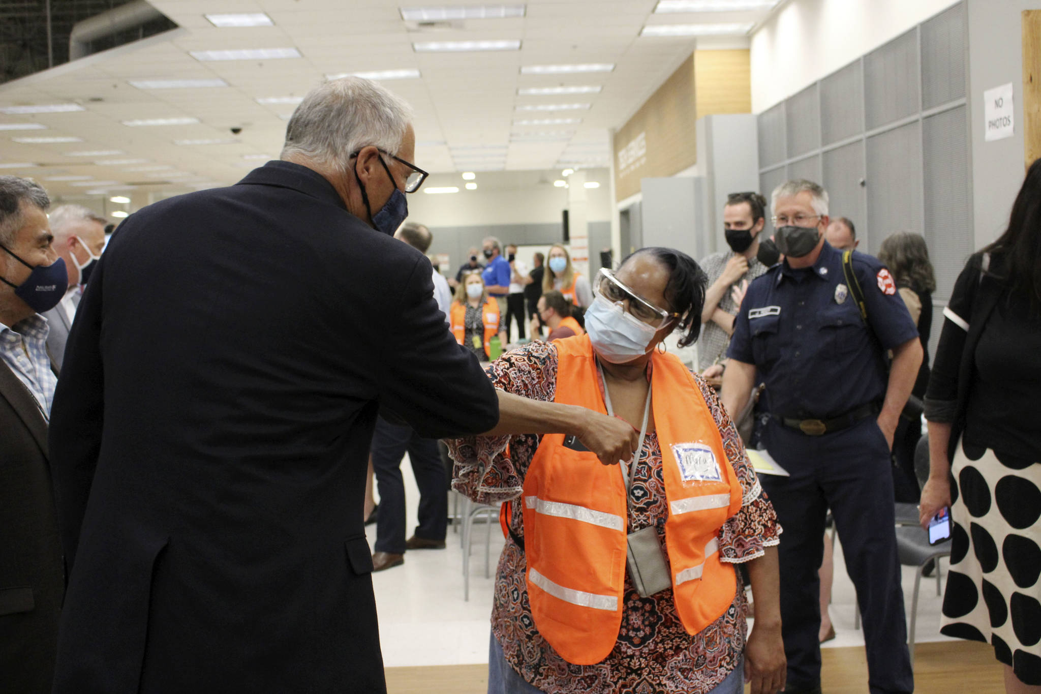 Gov. Jay Inslee (left) bumps elbows with Auburn Vaccine Clinic staff member Mary Johnson (right) on June 22, 2021. Inslee visited the clinic to promote vaccinations in lower King County. Photo by Henry Stewart-Wood/Sound Publishing